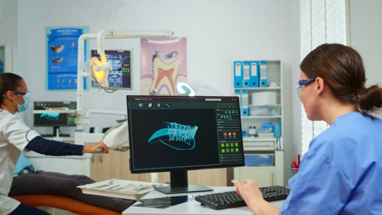 Orthodontist looking at teeth on a screen